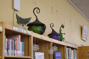 Along the shelves and walls of Westcott's Petit Branch Library, art painted and sculpted by Paula Uche and Deborah Hollihan is displayed as part of the “Dancing in the Light” exhibit.